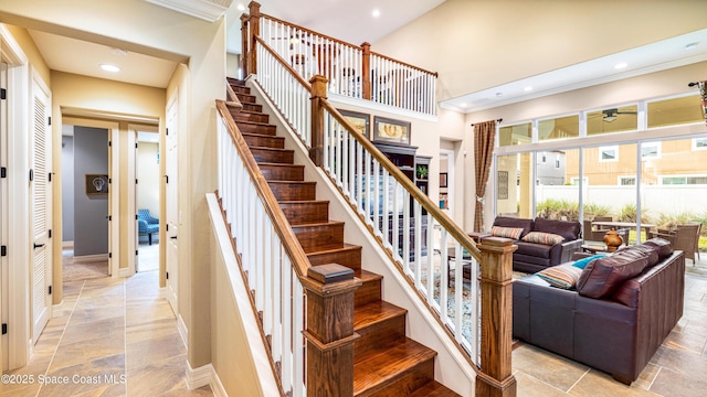 2683 Amati Dr, Kissimmee, FL 34741 - stairway with stone tile floors, a ceiling fan, ornamental molding, recessed lighting, and a high ceiling