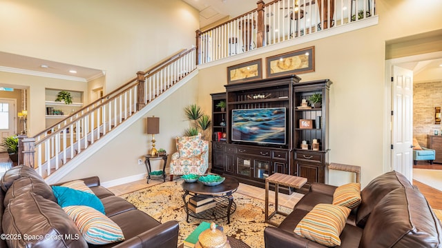 2683 Amati Dr, Kissimmee, FL 34741 - living room featuring a high ceiling, stairs, crown molding, and built in features