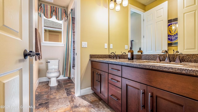 2683 Amati Dr, Kissimmee, FL 34741 - bathroom featuring double vanity and stone finish floors
