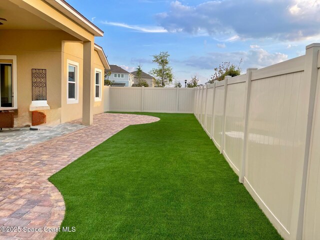 2683 Amati Dr, Kissimmee, FL 34741 - fenced backyard with a patio area