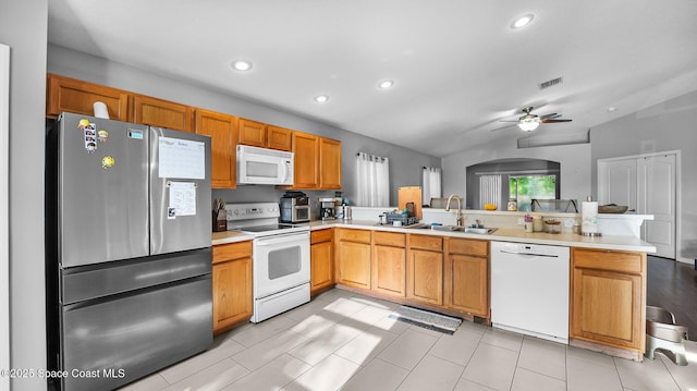 1119 Macon Dr, Titusville, FL 32780 - kitchen featuring white appliances, a peninsula, light countertops, ceiling fan, and recessed lighting