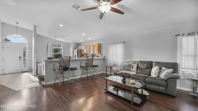 1119 Macon Dr, Titusville, FL 32780 - living area featuring wood finished floors, ceiling fan, a textured ceiling, lofted ceiling, and recessed lighting