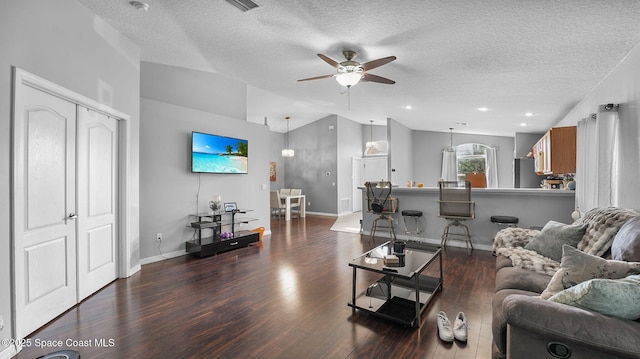 1119 Macon Dr, Titusville, FL 32780 - living area featuring wood finished floors, vaulted ceiling, a textured ceiling, and a ceiling fan