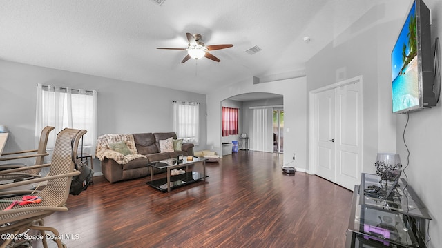 1119 Macon Dr, Titusville, FL 32780 - living room with arched walkways, ceiling fan, wood finished floors, and vaulted ceiling