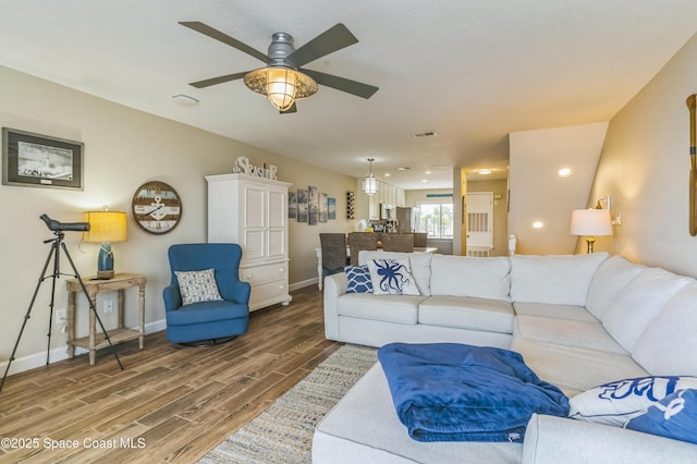 57 Broad St Unit 6, Titusville, FL 32796 - living area featuring wood finished floors, a ceiling fan, and recessed lighting