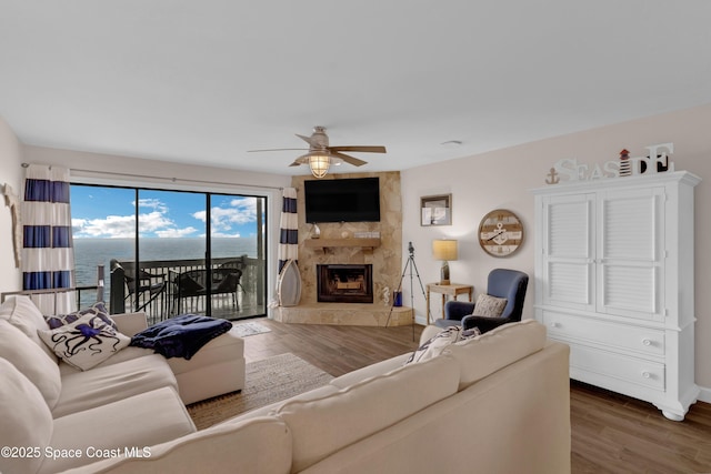 57 Broad St Unit 6, Titusville, FL 32796 - living area featuring a ceiling fan, wood finished floors, and a high end fireplace
