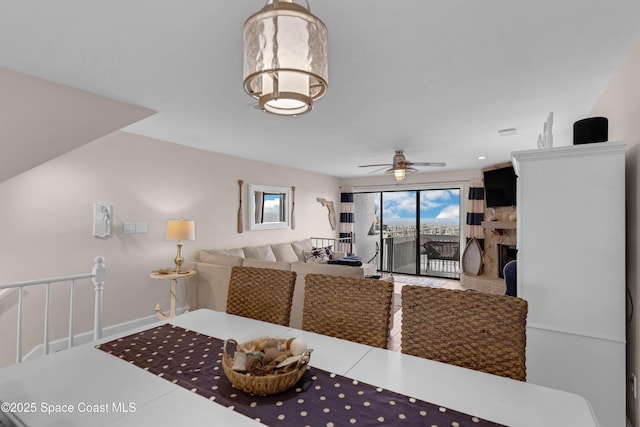 57 Broad St Unit 6, Titusville, FL 32796 - living area featuring a ceiling fan and a fireplace with raised hearth