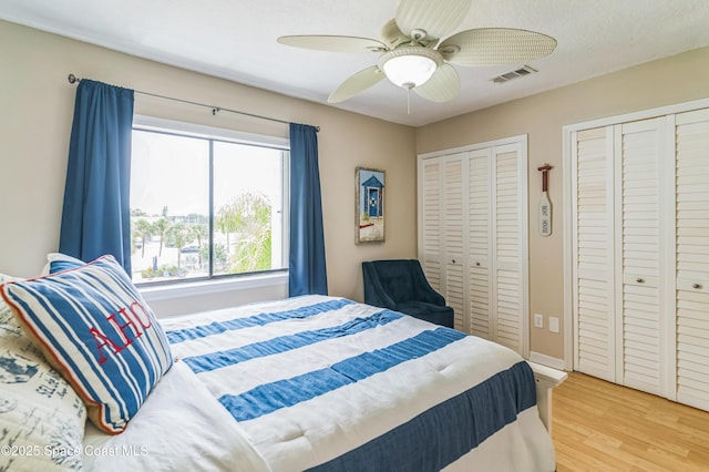 57 Broad St Unit 6, Titusville, FL 32796 - bedroom with multiple closets, light wood finished floors, and a ceiling fan
