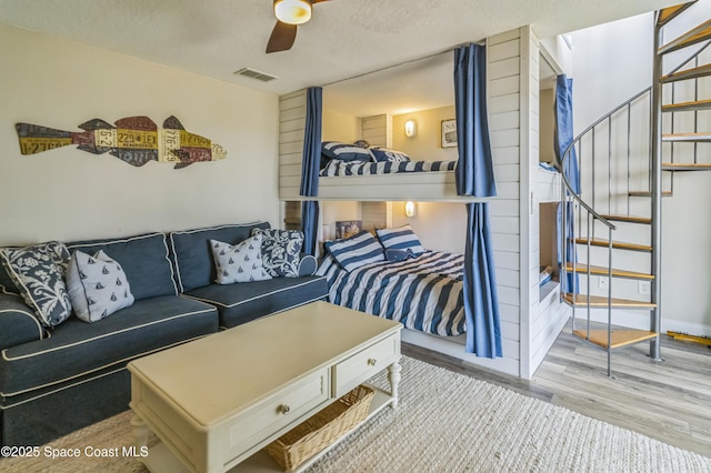 57 Broad St Unit 6, Titusville, FL 32796 - living room featuring ceiling fan, wood finished floors, and stairway