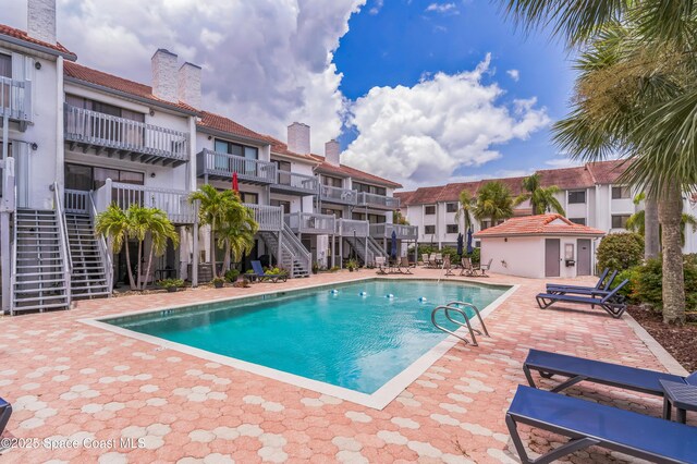 57 Broad St Unit 6, Titusville, FL 32796 - community pool with stairs, a patio, and a residential view