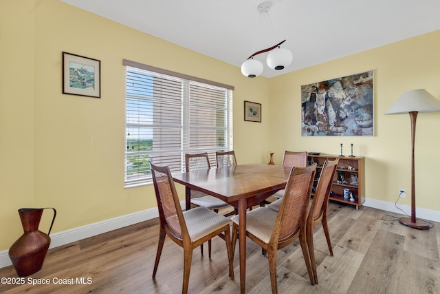 10777 W Sample Rd Unit 1212, Coral Springs, FL 33067 - dining space with light wood-style floors and baseboards