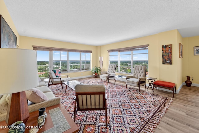 10777 W Sample Rd Unit 1212, Coral Springs, FL 33067 - living area featuring wood finished floors and a textured ceiling