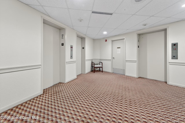 10777 W Sample Rd Unit 1212, Coral Springs, FL 33067 - carpeted empty room with a paneled ceiling, elevator, and a smoke detector