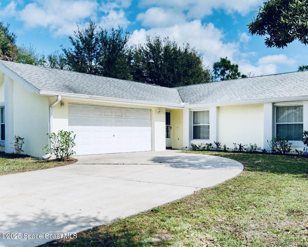 171 Krefeld Rd NW, Palm Bay, FL 32907 - single story home with stucco siding, an attached garage, driveway, a front yard, and roof with shingles