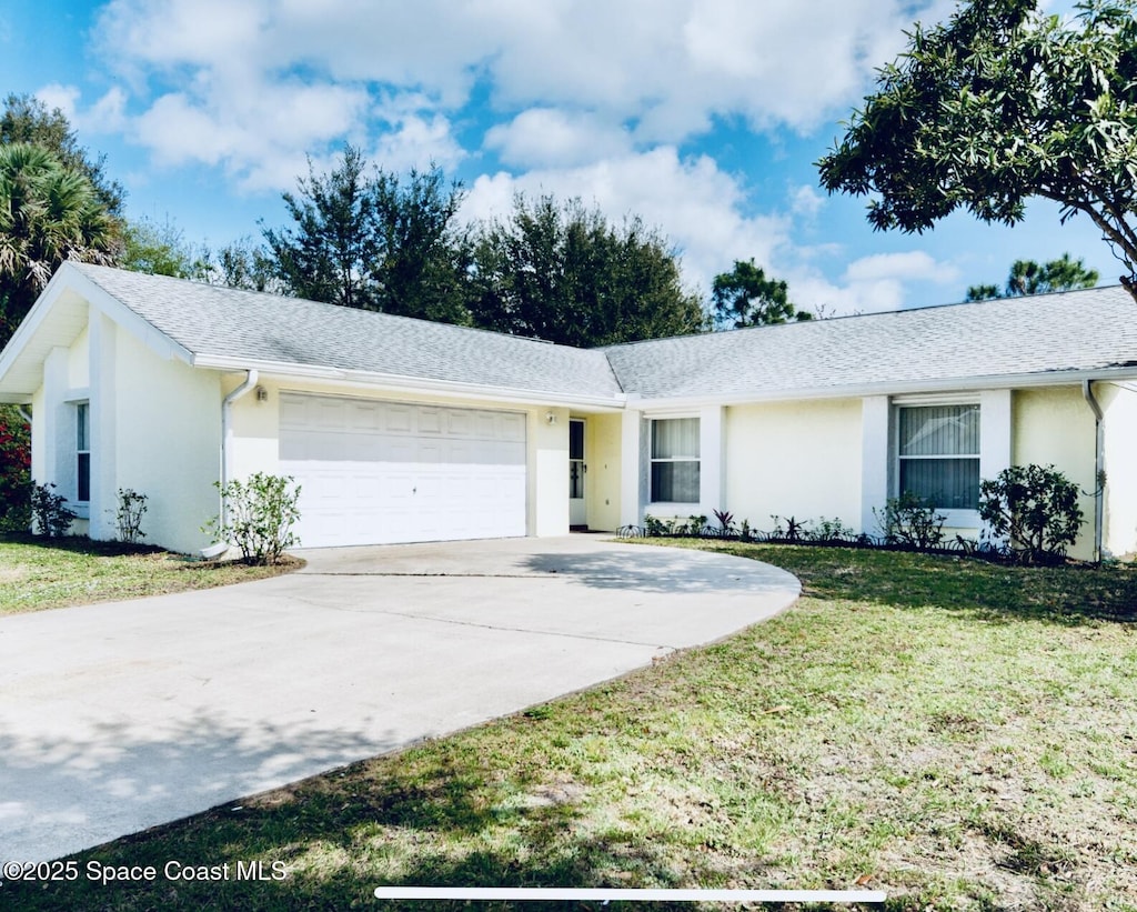 171 Krefeld Rd NW, Palm Bay, FL 32907 - single story home featuring stucco siding, an attached garage, concrete driveway, and a front yard