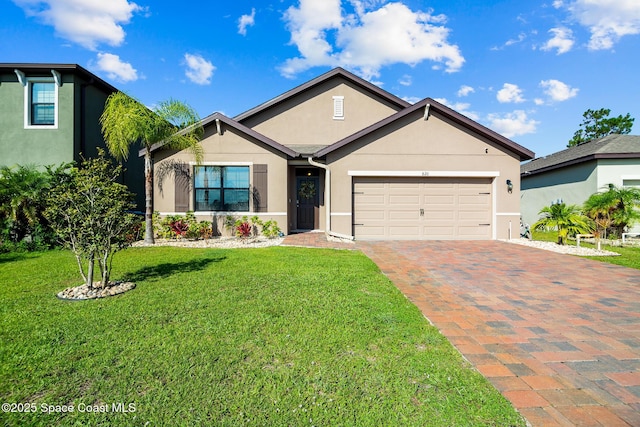 820 Old Country Rd SE, Palm Bay, FL 32909 - view of front of home with stucco siding, a garage, decorative driveway, and a front lawn
