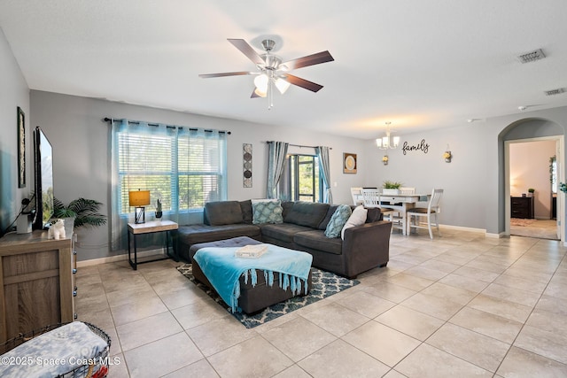 820 Old Country Rd SE, Palm Bay, FL 32909 - living area with light tile patterned flooring, a ceiling fan, arched walkways, and a chandelier