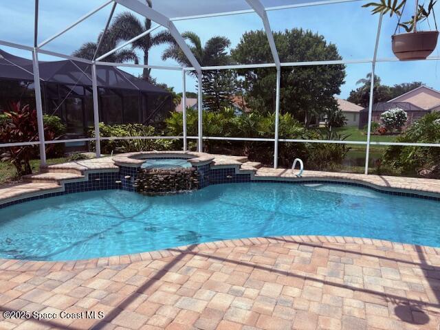 968 Shaw Cir, Melbourne, FL 32940 - view of swimming pool with a pool with connected hot tub, glass enclosure, and a patio