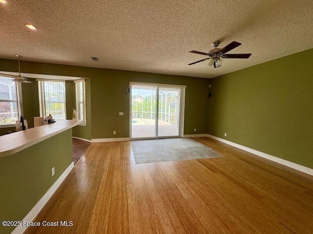 968 Shaw Cir, Melbourne, FL 32940 - unfurnished room with wood finished floors, a textured ceiling, ceiling fan, and recessed lighting