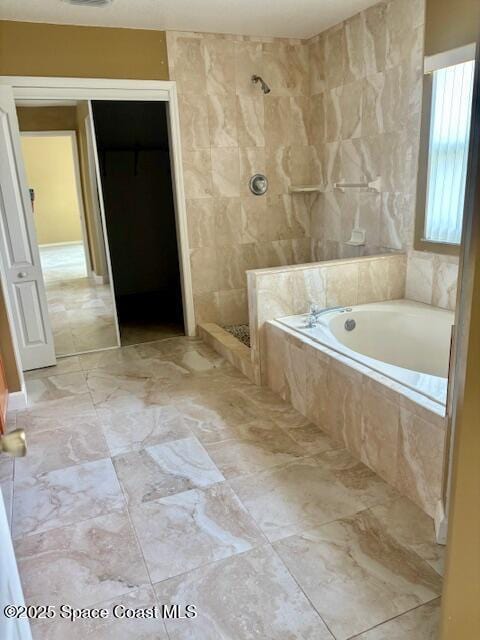 968 Shaw Cir, Melbourne, FL 32940 - bathroom featuring a bath, a tile shower, and marble look tiles