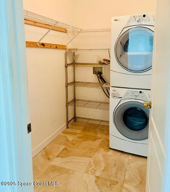 968 Shaw Cir, Melbourne, FL 32940 - laundry area with stacked washing machine and dryer