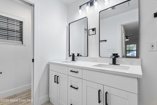 4890 Yew Ct, Titusville, FL 32796 - bathroom featuring double vanity, wood finished floors, and ceiling fan