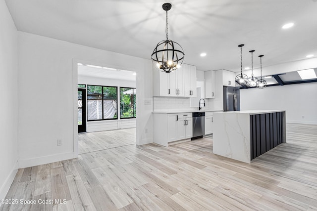4890 Yew Ct, Titusville, FL 32796 - kitchen featuring stainless steel appliances, light countertops, white cabinetry, recessed lighting, and light wood-style floors