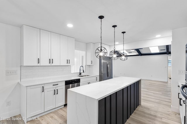 4890 Yew Ct, Titusville, FL 32796 - kitchen with stainless steel appliances, white cabinetry, a center island, decorative backsplash, and recessed lighting