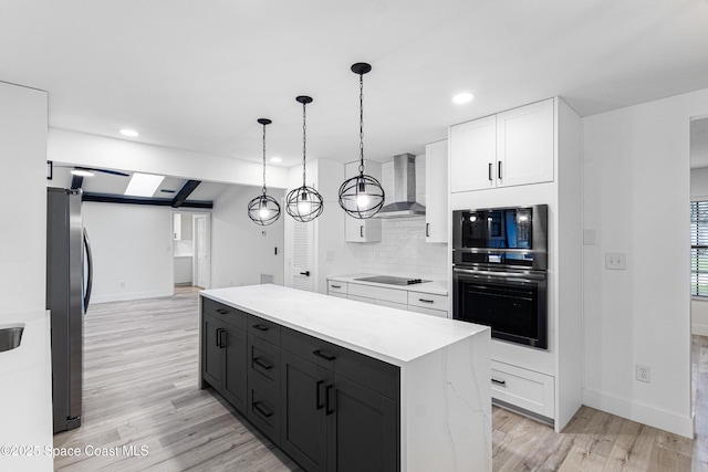 4890 Yew Ct, Titusville, FL 32796 - kitchen with wall chimney exhaust hood, built in microwave, white cabinetry, light wood-style flooring, and light countertops