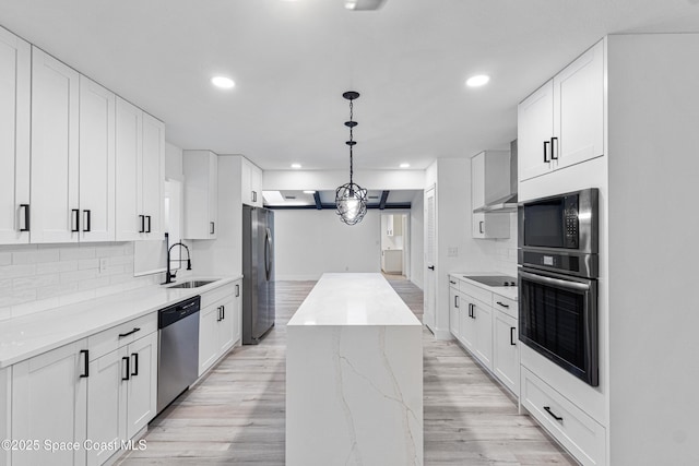 4890 Yew Ct, Titusville, FL 32796 - kitchen with black appliances, recessed lighting, backsplash, light wood finished floors, and a kitchen island