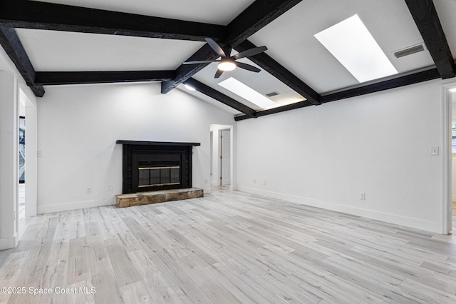 4890 Yew Ct, Titusville, FL 32796 - unfurnished living room featuring a ceiling fan, a skylight, wood finished floors, and a glass covered fireplace