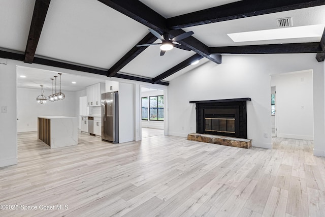 4890 Yew Ct, Titusville, FL 32796 - unfurnished living room with light wood finished floors, a ceiling fan, a skylight, a glass covered fireplace, and recessed lighting
