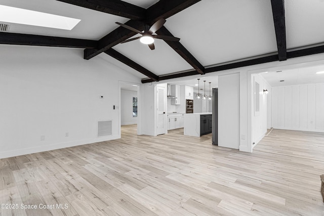 4890 Yew Ct, Titusville, FL 32796 - unfurnished living room with a skylight, a ceiling fan, light wood-type flooring, and a chandelier