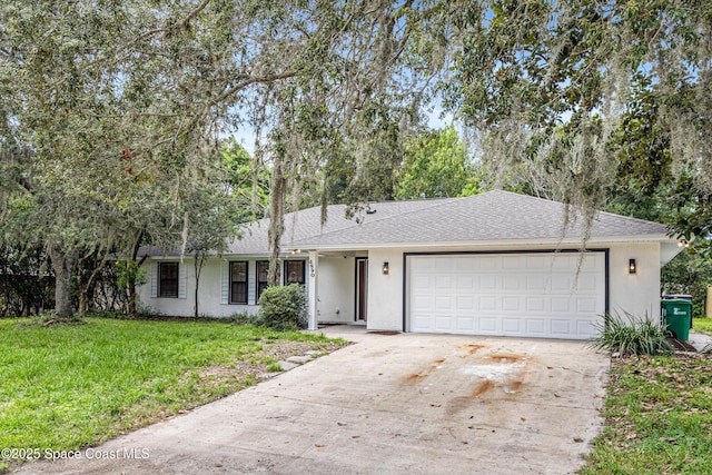 4890 Yew Ct, Titusville, FL 32796 - single story home with an attached garage, driveway, a front lawn, a shingled roof, and stucco siding