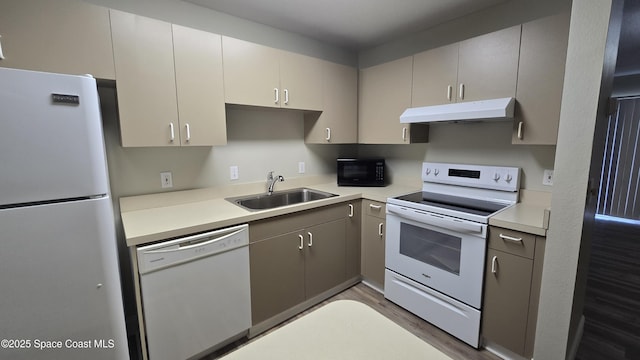 1820 Long Iron Dr Unit 525, Rockledge, FL 32955 - kitchen featuring white appliances, under cabinet range hood, wood finished floors, and light countertops