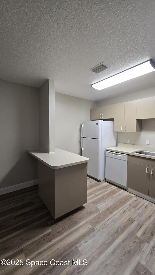 1820 Long Iron Dr Unit 525, Rockledge, FL 32955 - kitchen with white appliances, light wood-style floors, light countertops, and a textured ceiling