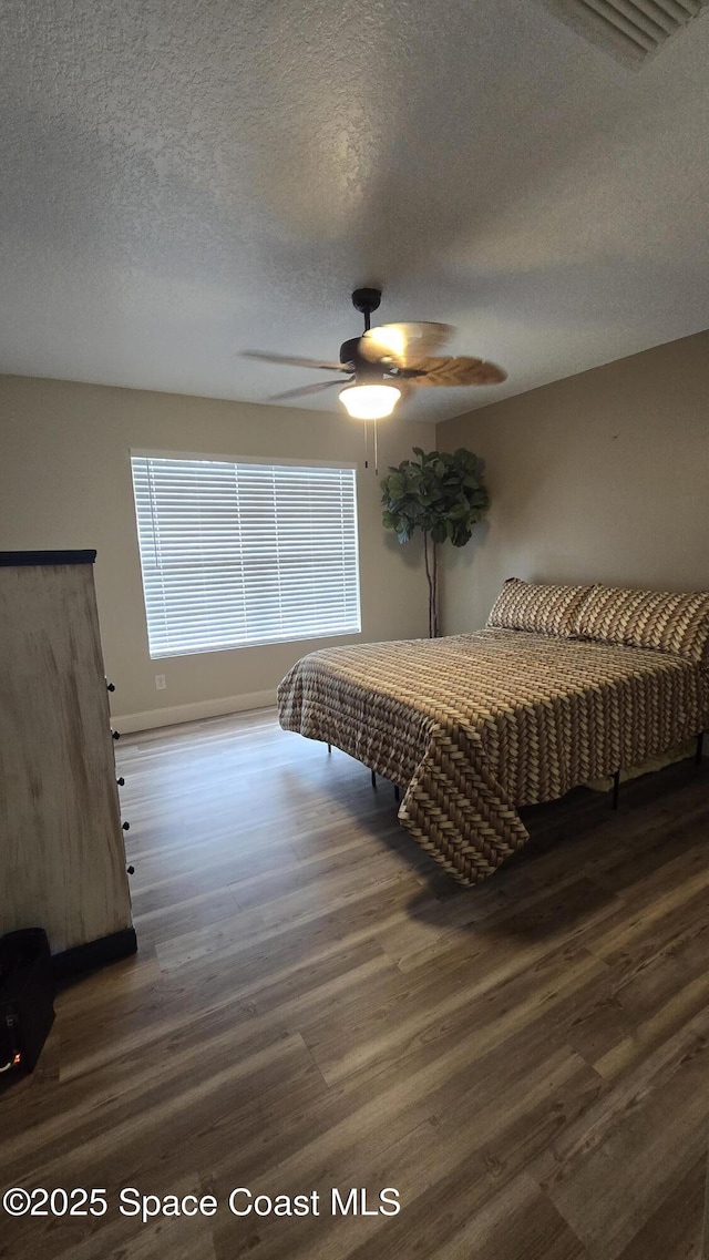 1820 Long Iron Dr Unit 525, Rockledge, FL 32955 - bedroom featuring wood finished floors, a textured ceiling, and a ceiling fan