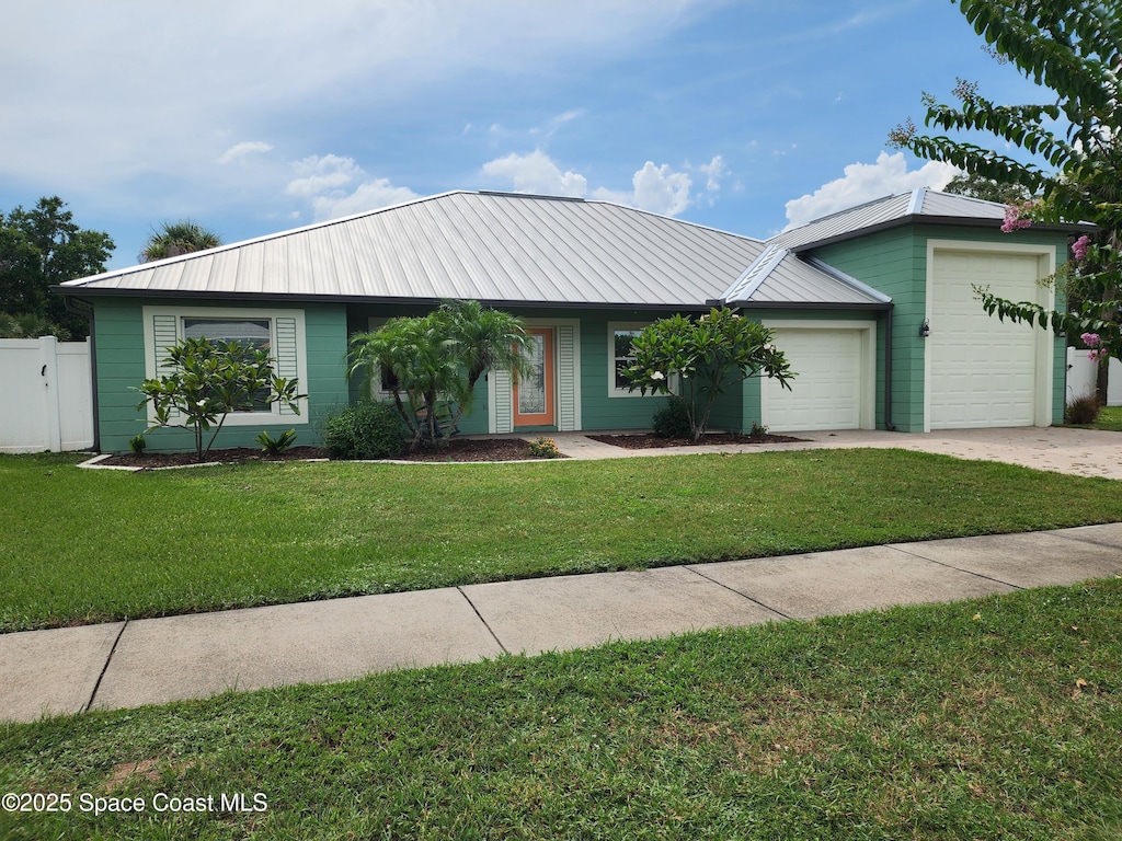 370 Jennifer Dr, Titusville, FL 32796 - ranch-style home with an attached garage, a metal roof, and driveway
