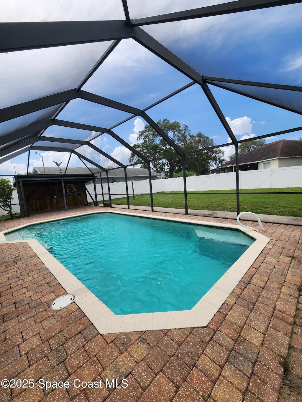370 Jennifer Dr, Titusville, FL 32796 - swimming pool featuring a patio area and glass enclosure