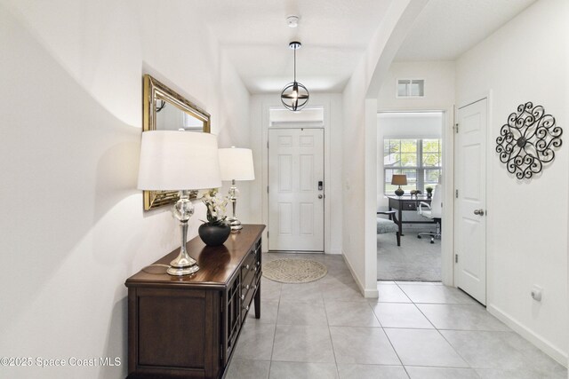 1669 Mineral Loop Dr NW, Palm Bay, FL 32907 - foyer featuring arched walkways and light tile patterned floors