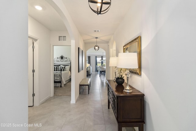 1669 Mineral Loop Dr NW, Palm Bay, FL 32907 - hall featuring arched walkways and light tile patterned floors