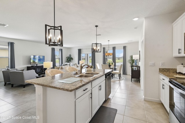 1669 Mineral Loop Dr NW, Palm Bay, FL 32907 - kitchen featuring a chandelier, open floor plan, light tile patterned floors, and appliances with stainless steel finishes