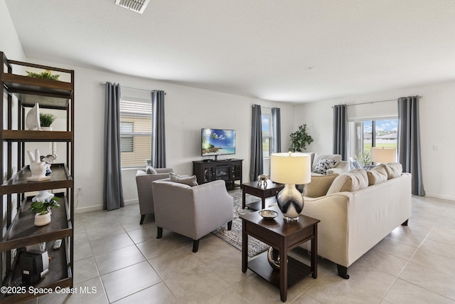 1669 Mineral Loop Dr NW, Palm Bay, FL 32907 - living room featuring healthy amount of natural light and light tile patterned floors