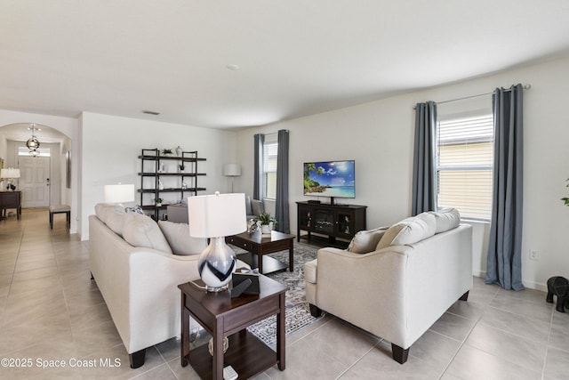 1669 Mineral Loop Dr NW, Palm Bay, FL 32907 - living room with arched walkways and light tile patterned flooring