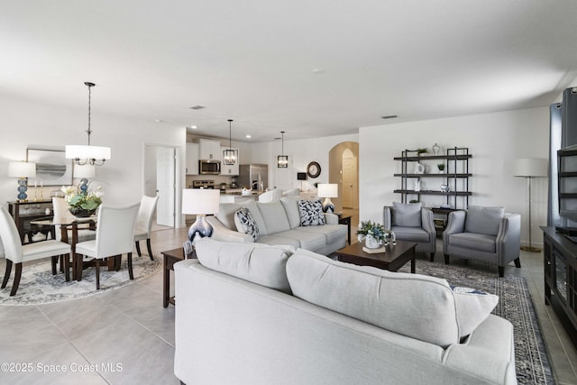 1669 Mineral Loop Dr NW, Palm Bay, FL 32907 - living area with arched walkways, recessed lighting, and light tile patterned floors