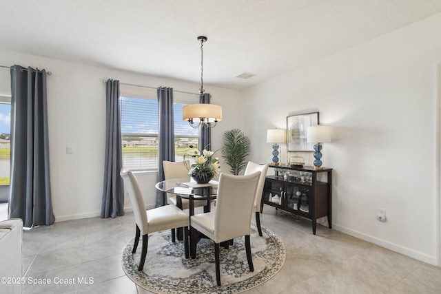 1669 Mineral Loop Dr NW, Palm Bay, FL 32907 - dining area featuring a chandelier and light tile patterned flooring