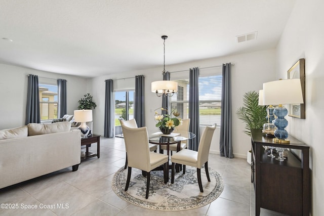 1669 Mineral Loop Dr NW, Palm Bay, FL 32907 - dining area with a chandelier and light tile patterned floors