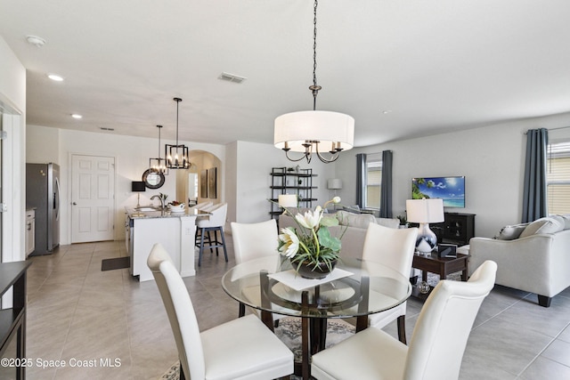 1669 Mineral Loop Dr NW, Palm Bay, FL 32907 - dining area featuring light tile patterned flooring, a chandelier, and recessed lighting