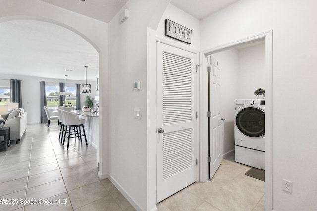 1669 Mineral Loop Dr NW, Palm Bay, FL 32907 - laundry room with arched walkways, washer / clothes dryer, and light tile patterned flooring