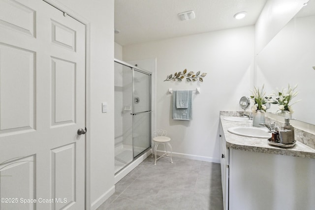 1669 Mineral Loop Dr NW, Palm Bay, FL 32907 - bathroom with double vanity, a stall shower, and tile patterned flooring